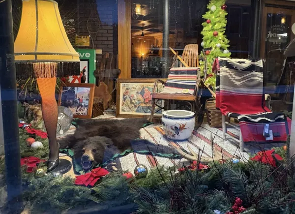 The shop window filled with rugs, lamps and pelts
